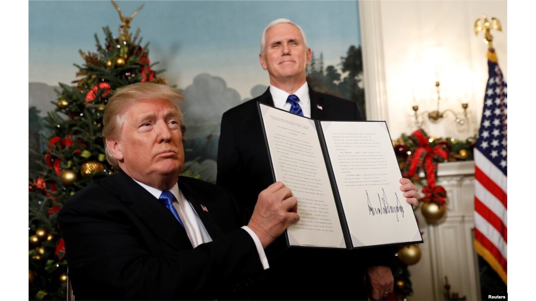 FILE - After signing, U.S. President Donald Trump holds up the proclamation that the United States recognizes Jerusalem as the capital of Israel and will move its embassy there, during an address from the White House in Washington, U.S., Dec. 6, 2017.