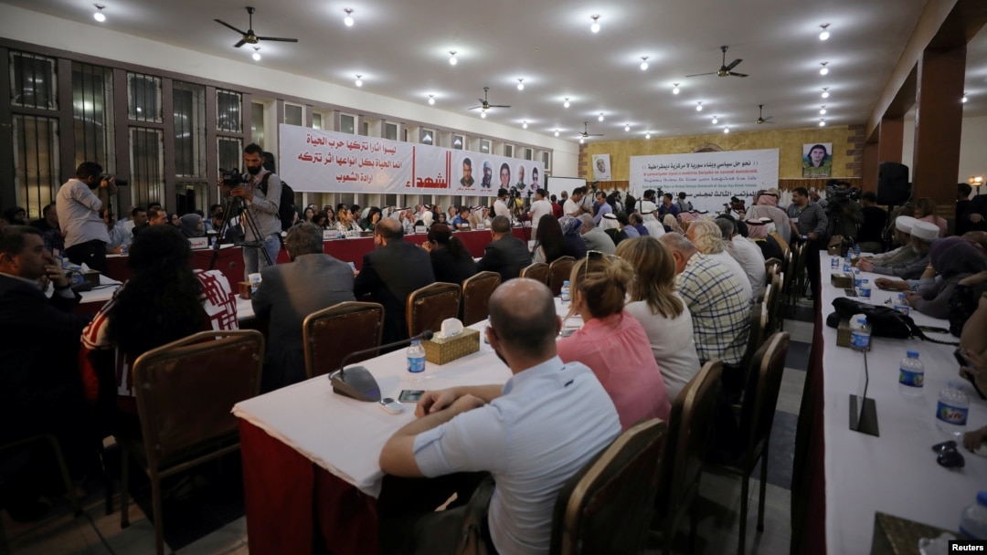 FILE - The Syrian Democratic Council meets in Tabqa, Syria, July 16, 2018.