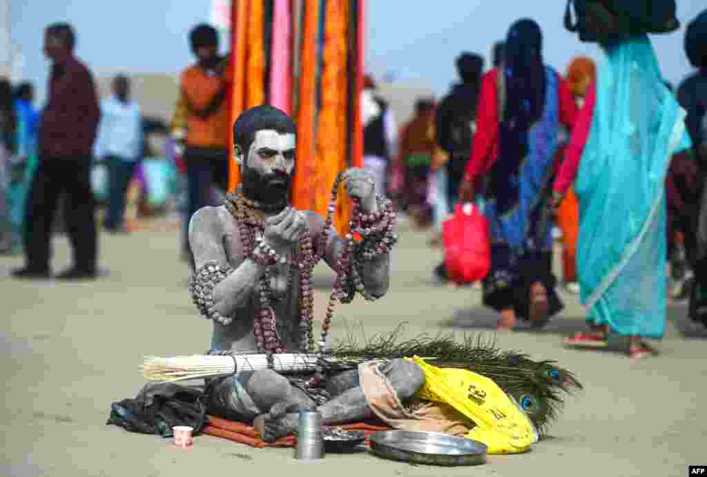 An Indian sadhu (Hindu holy man) sits on the banks of Sangam -- the confluence of the Ganges, Yamuna and mythical Saraswati rivers -- on the auspicious bathing day of 'Maghi Purnima' during the Kumbh Mela festival in Allahabad.