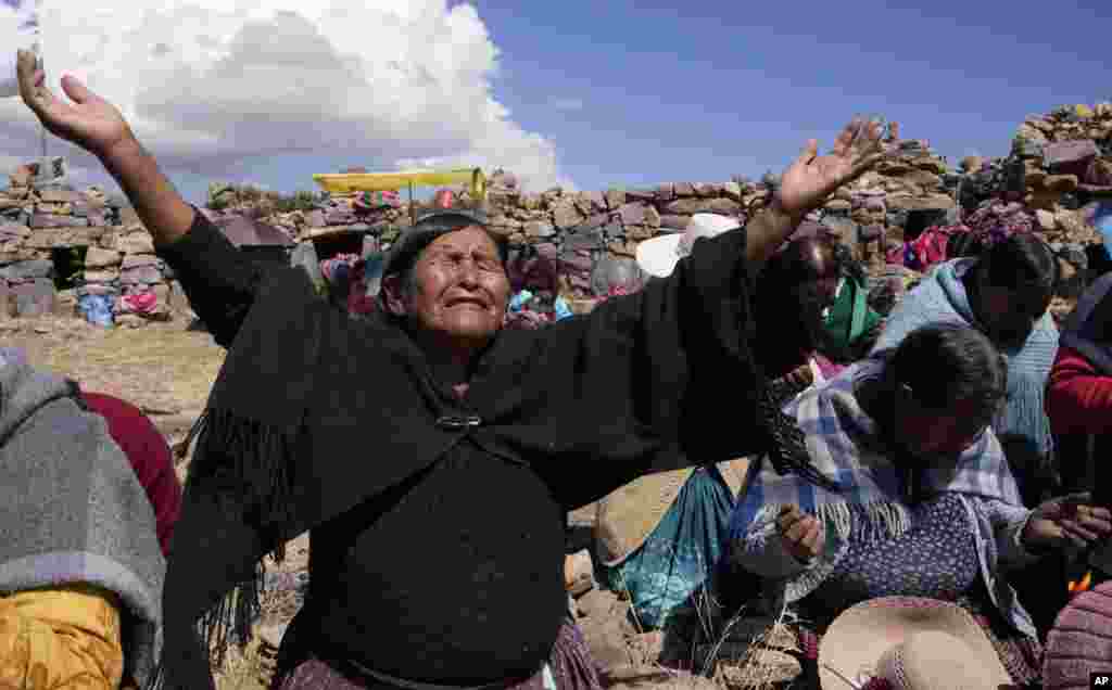 Aymara Indigenous women pray on a day of fasting in a call for rain on the sacred Inca Pucara mountain in Chiquipata, Bolivia, Nov. 16, 2022.