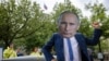 FILE - An activist wearing a mask of Russia's President Vladimir Putin stands in front of a mockup of a nuclear bomb during a demostration for the abolition of nuclear weapons in front of the Russian embassy in Berlin on June 23, 2023.