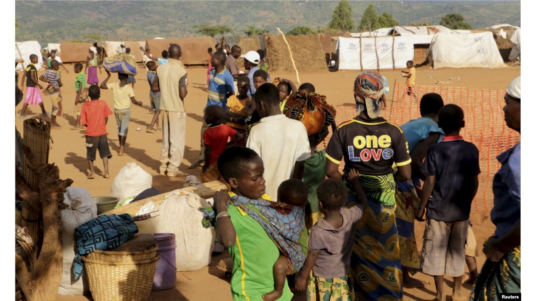 FILE - Refugees wait for registration at Kapise camp in Malawi's Mwanza district, Jan. 18, 2016.