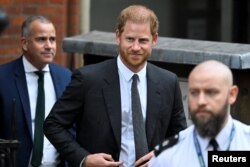 FILE - Britain's Prince Harry walks outside the High Court, in London, March 30, 2023.