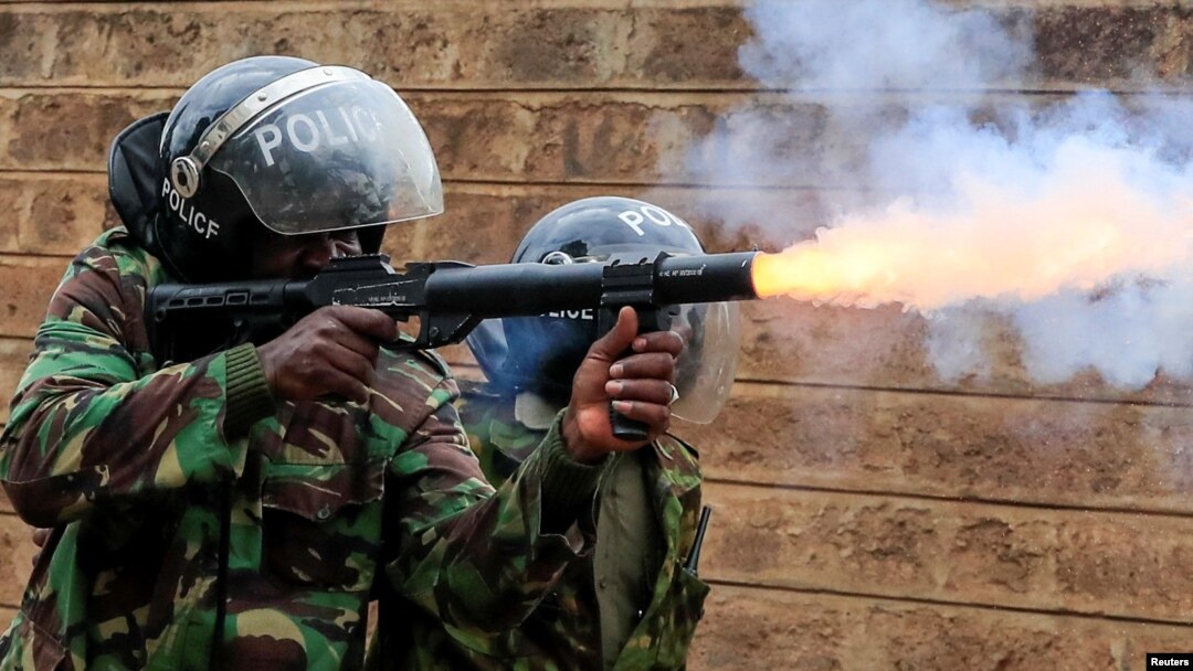 A riot police officer fires tear gas at protesters opposing the imposition of tax hikes by the government in Nairobi, Kenya, July 19, 2023.