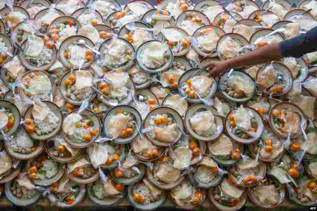 A man prepares meals for breaking fast during the Islamic holy month of Ramadan, at a mosque in Yogyakarta, Indonesia, March 28, 2023.