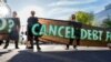 FILE - A small group of protestors block a street near the International Monetary and Financial Committee (IMFC) plenary session at the International Monetary Fund Building in Washington, Apr. 14, 2023. 