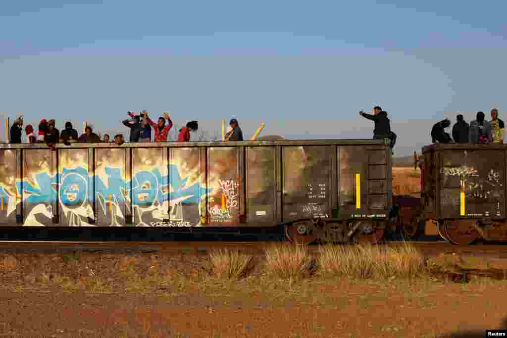 Migrants ride on a train toward Ciudad Juarez, in La Escuadra, Chihuahua, Mexico, March 28, 2023.