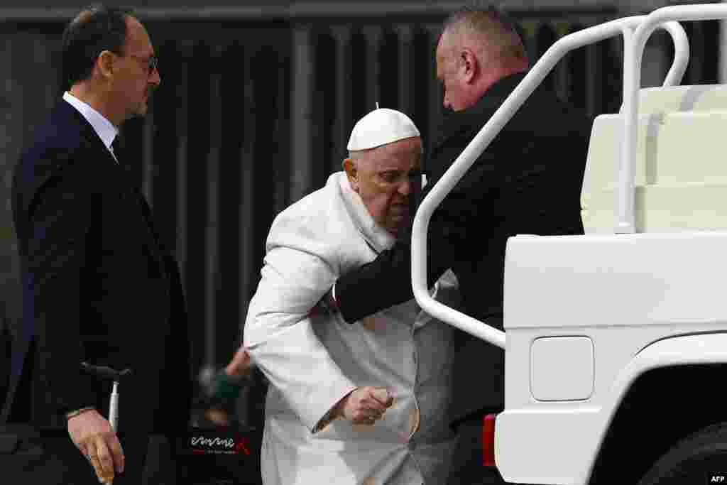 Pope Francis is helped into the popemobile after his weekly general audience at St. Peter's Square in the Vatican.