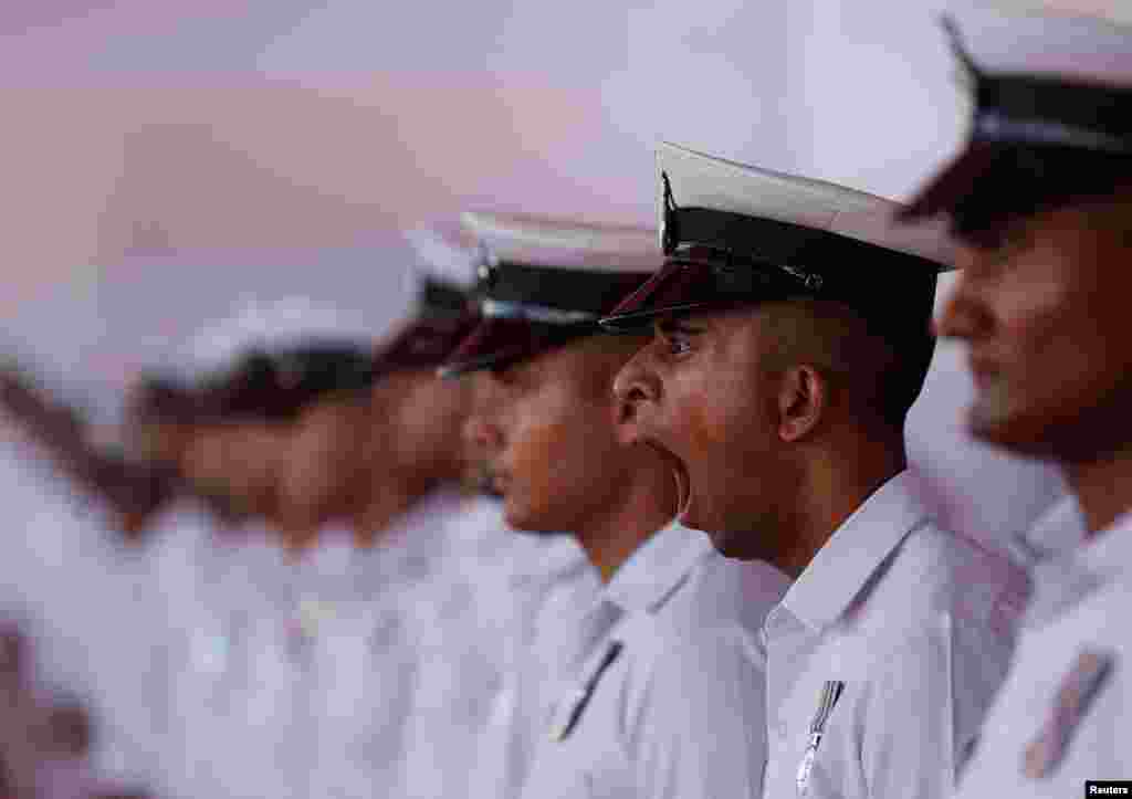 A navy personnel yawns before the commissioning ceremony of INS Imphal, a stealth guided missile destroyer and the third warship of Project-15B, at the Naval Dockyard, in Mumbai, India.