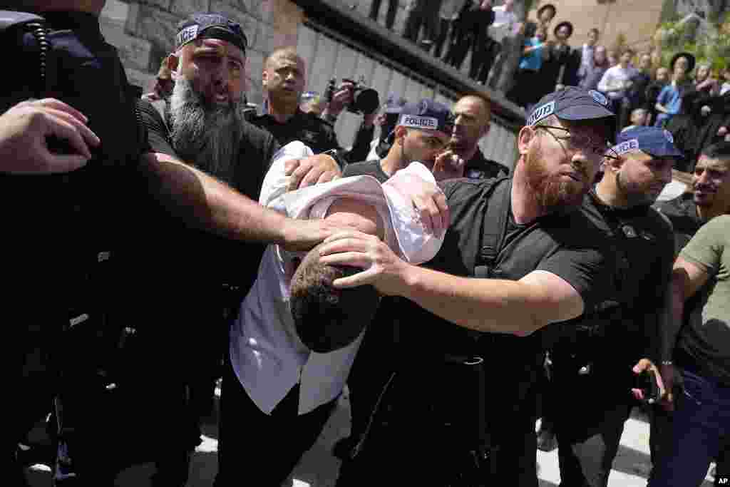 Israeli police detain a suspected attacker in an apparent car ramming that wounded three people on the eve of the Jewish holiday of Passover, in Jerusalem.