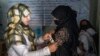FILE - An Afghan woman is checked by a nutritionist at a clinic run by the World Food Program, in Kabul, Afghanistan, Jan. 26, 2023. The Taliban has restricted the rights of Afghan women, including prohibiting Afghan women from working for the United Nations in Afghanistan.