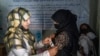 FILE - An Afghan woman is checked by a nutritionist at a clinic run by the WFP, in Kabul, Afghanistan, Jan. 26, 2023. 