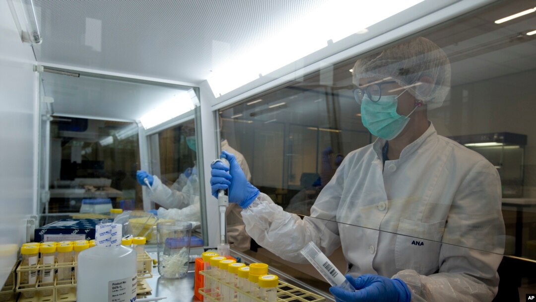 FILE - Employees demonstrate DNA sampling in The Hague, Netherlands, Oct. 24, 2017. Ukrainian groups have visited an organization that uses high-tech DNA techniques to identify people who go missing in conflicts. 