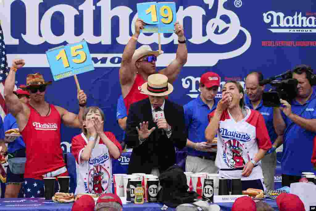 Miki Sudo, right, and Mayoi Ebihara, left, compete in the women's division of Nathan's Famous Fourth of July hot dog eating contest at Coney Island in the Brooklyn borough of New York. Sudo won by eating a record 51 hot dogs. 