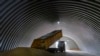 FILE - A truck unloads grain in the village of Zghurivka, Ukraine, Aug. 9, 2022. 