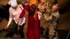 In this handout image, provided by the U.K. Ministry of Defense, on April 26, 2023, British nationals board an RAF aircraft in Akrotiri, Cyprus, after being evacuated from Sudan. (Mark Johnson/UK Ministry of Defense via AP)