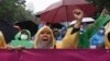 Women activists shout during a rally celebrating International Women's Day in Jakarta, Indonesia, March 8, 2023.