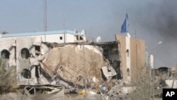 FILE - People inspect the rubble of the Canal Hotel after an explosion on Aug. 19, 2003, in Baghdad, Iraq. United Nations officials on Aug. 19, 2023, marked the 20th anniversary of the deadly attack on the U.N. headquarters in Baghdad.