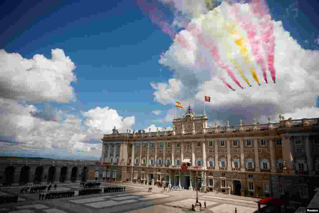 The aerobatic team "Patrulla Aguila" (Eagle Patrol) of the Spanish Air and Space Force flies past the Royal Palace during commemorations marking the 10th anniversary of the proclamation of Spain's King Felipe VI, in Madrid.