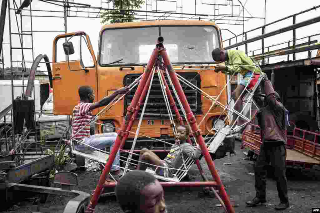 Young boys play on a swing made out of scrap metal underneath a makeshift platform called Kolas Space in the popular Ndjili neighborhood in Kinshasa.
