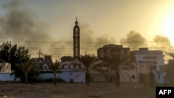 Smoke rises above buildings in southern Khartoum, as violence between two rival Sudanese generals continues, on May 17, 2023.