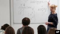FILE - Olha Kovalevska, a teacher of Ukrainian literature at a school run by the Unbreakable Ukraine foundation in Warsaw, Poland, instructs refugee students on June 3, 2023.