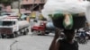 Trucks block the street as residents protest against gangs who control most of the metropolitan area of the capital, in Port-au-Prince, Haiti, April 25, 2023. 