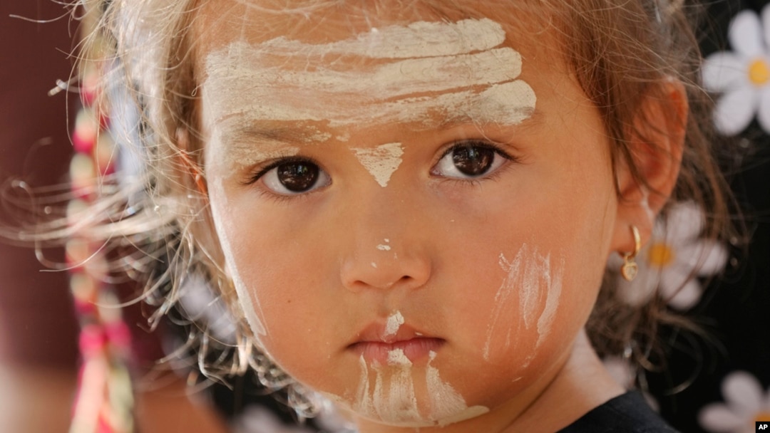 Elouera Dephoff, 2, has traditional paint adornments on her face while attending an Indigenous Australians protest during Australia Day in Sydney, Jan. 26, 2024. 