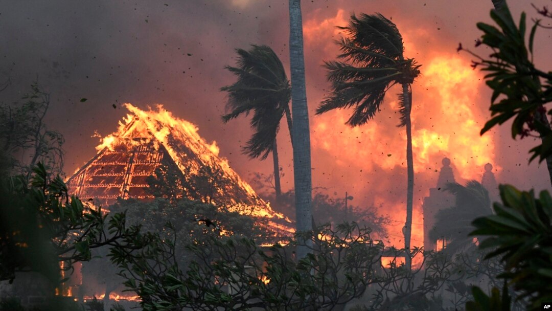 FILE - The hall of historic Waiola Church in Lahaina and nearby Lahaina Hongwanji Mission are engulfed in flames along Wainee Street on Aug. 8, 2023, in Lahaina, Hawaii.