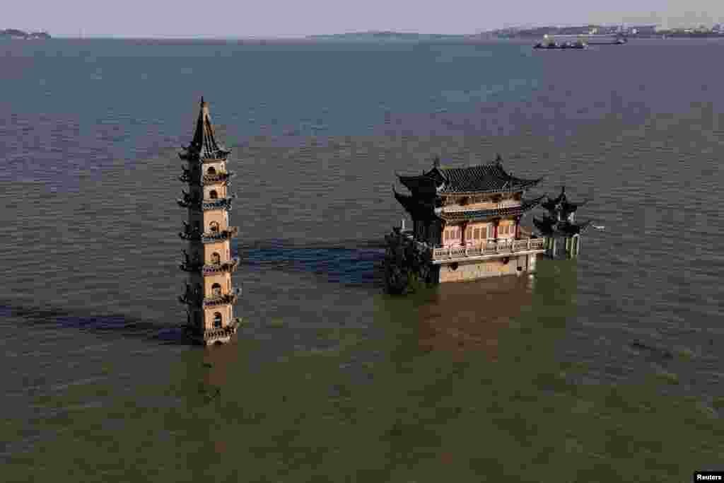 A drone view shows partially submerged temple and pagoda atop Luoxingdun island as water levels at Poyang lake are nearing historic high following heavy rainfall in the region, in Lushan, Jiangxi province, China.
