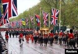 On Coronation Day, King Charles III and Queen Camilla ride in a gold state coach — built in 1762 and used in every coronation since 1831 — in London, May 6, 2023.