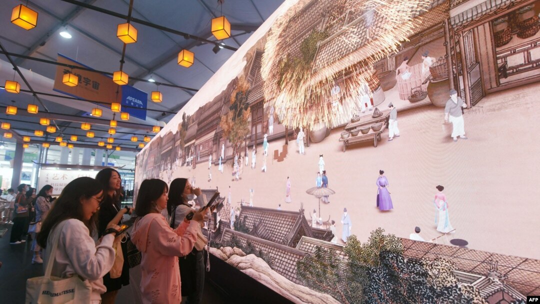 FILE - People watch a digital image at the Apsara Conference, a cloud computing and artificial intelligence conference, in Hangzhou, in China's eastern Zhejiang province on Nov. 3, 2022.