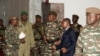 General Abdourahamane Tchiani, center, who was declared the new head of state of Niger by leaders of a coup, arrives to meet with ministers in Niamey, Niger, July 28, 2023. 