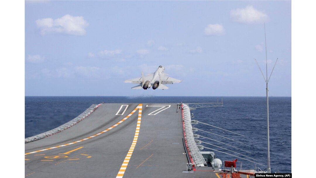 A J-15 Chinese fighter jet takes off from the Shandong aircraft carrier during the combat readiness patrol and military exercises around the Taiwan Island, April 9, 2023.