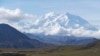 FILE - Sightseeing buses and tourists are seen at a pullout popular for taking in views of North America's tallest peak, Denali, in Denali National Park and Preserve, Alaska, Aug. 26, 2016.