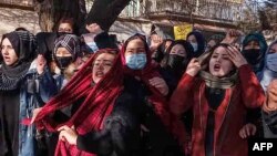 FILE - Afghan women chant slogans to protest against the ban on university education for women, in Kabul on Dec. 22, 2022.