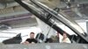 Ukrainian President Volodymyr Zelenskyy, left, and Danish Prime Minister Mette Frederiksen sit in a F-16 fighter jet in the hangar of the Skrydstrup Airbase in Vojens, northern Denmark, on Aug. 20, 2023. 