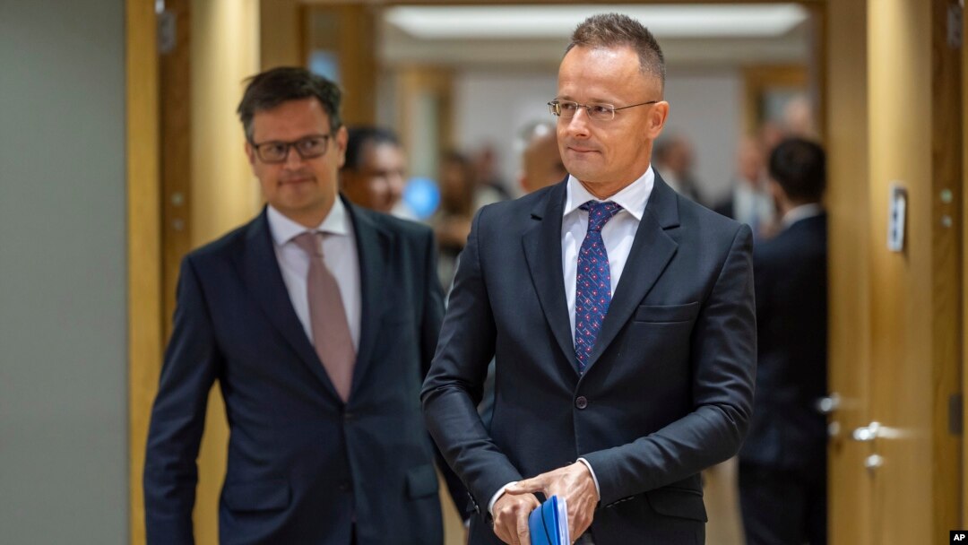 Hungary's Foreign Minister Peter Szijjarto, right, arrives for a meeting of EU foreign ministers at the European Council building in Brussels, July 22, 2024. 