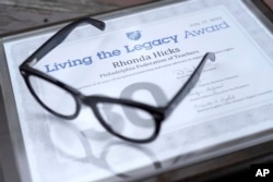The Living the Legacy award given to Rhonda Hicks is shown at her home in Philadelphia, Thursday, July 20, 2023. The award is from the American Federation of Teachers in recognition of 30 years of exceptional leadership and union advocacy in support of women's rights. (AP Photo/Michael Perez)