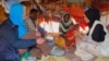 FILE - Cindy McCain, left, executive director of the U.N. World Food Program, meets an internally displaced Somali family at the Ladan camp for IDPs in Dollow, Somalia, May 1, 2023.