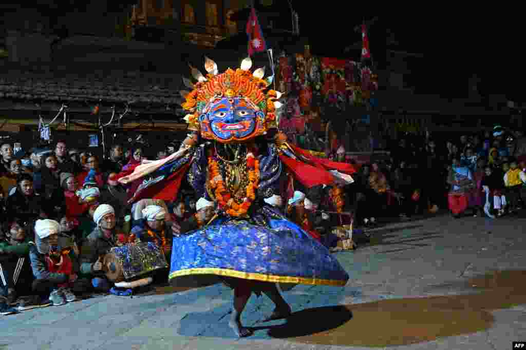 A traditional masked dancer performs during Pachali Bhairav dance festival in Kathmandu, Nepal.
