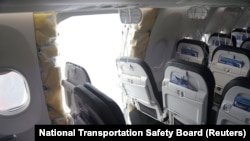 FILE - The fuselage plug area of Alaska Airlines Flight 1282 Boeing 737-9 MAX, which was forced to land with a gap in the fuselage, is seen during its investigation by the NTSB in Portland, Oregon, Jan. 7, 2024. (NTSB/handout via Reuters)