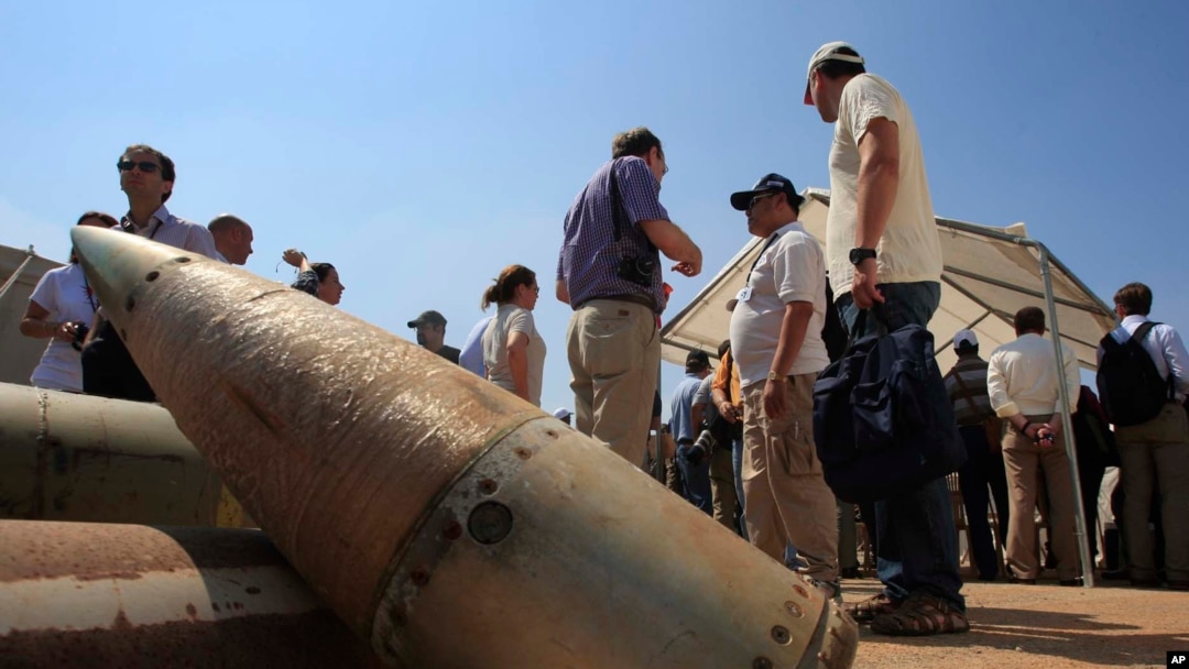Activists stand near cluster bombs in Lebanon on Sept. 12, 2011. The United States provided cluster bombs to Kyiv in July 2023.