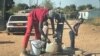 Residents of Sizinda, urban Bulawayo, Zimbabwe, fetching water from a borehole.