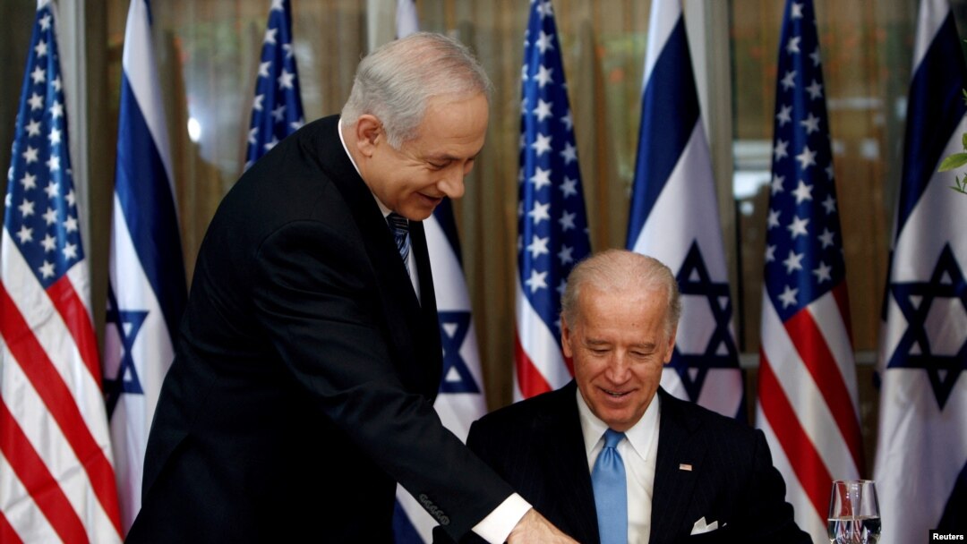 FILE - U.S. Vice President Joe Biden (R) prepares to sign the guest book before his meeting with Israel's Prime Minister Benjamin Netanyahu at Netanyahu's residence in Jerusalem March 9, 2010. 