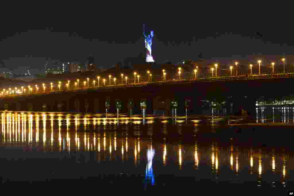 The Ukrainian Motherland monument is illuminated in the colors of an American flag in celebration of the United States' Independence Day in Kyiv, July 4, 2023.