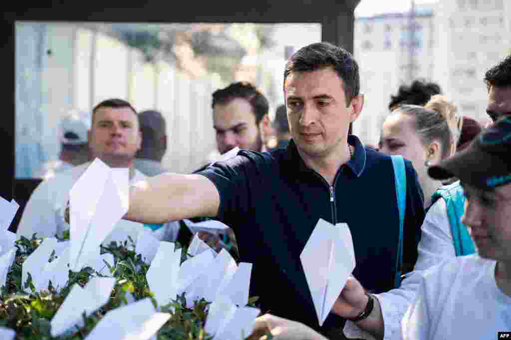 This handout photograph posted on the official Telegram channel of the Vice Speaker of the State Duma from the "New People" party, Andrei Davankov, shows party supporters displaying paper planes as a reference to the logo of Telegram outside France's Embassy in central Moscow, in support of Pavel Durov, founder and CEO of the messaging app. Dirov was arrested earlier at the Le Bourget Paris airport, France, for offences related to his popular messaging app