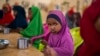 FILE - A child eats at a school in Dollow, Somalia, Sept. 19, 2022. At midday, dozens of hungry children from the camps try to slip into a local primary school where the World Food Program offers a lunch program for students.