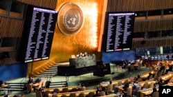 Video monitors show the member nations' vote in the United Nations General Assembly in favor of a resolution condemning Russia's illegal referendum in Ukraine, Oct. 12, 2022 at U.N. headquarters.