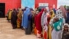 FILE - Somali women and children who left rural areas due to drought receive nutritional assistance at a camp for the internally displaced, on the outskirts of Baidoa, Somalia, Oct. 12, 2022.